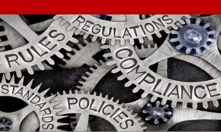 Gears interlocked with words like "Compliance," "Rules," and "Regulations," symbolizing the intricacies of regulatory frameworks in business.